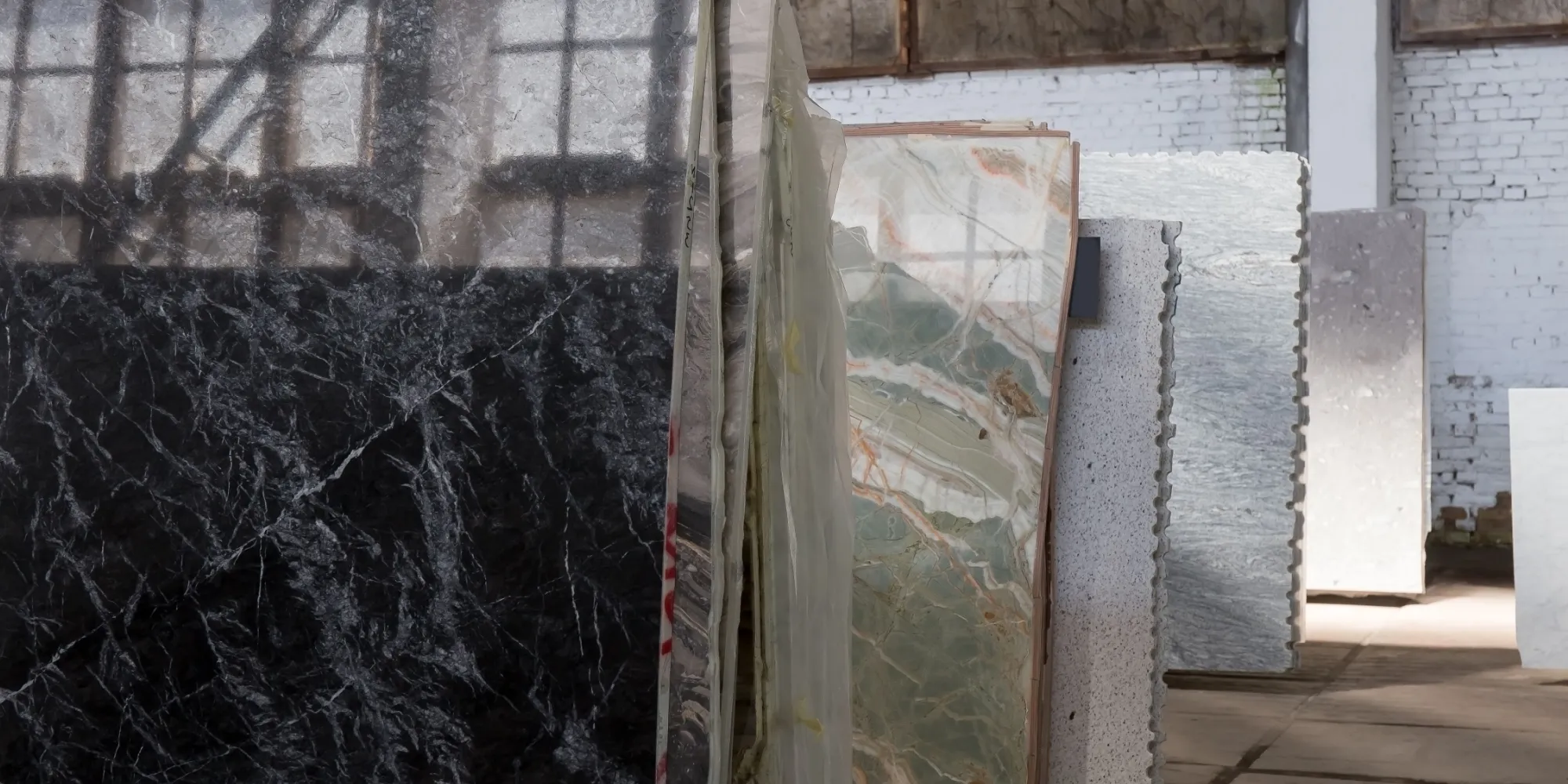 Stone slabs stored on A-frame racks in a warehouse